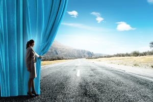 pulling back a curtain to reveal a road