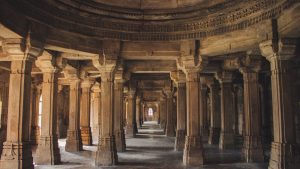 Explore the architectural brilliance of an ancient temple's stone columns and arches.