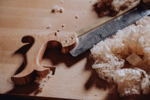 a knife and some wood shavings on a table