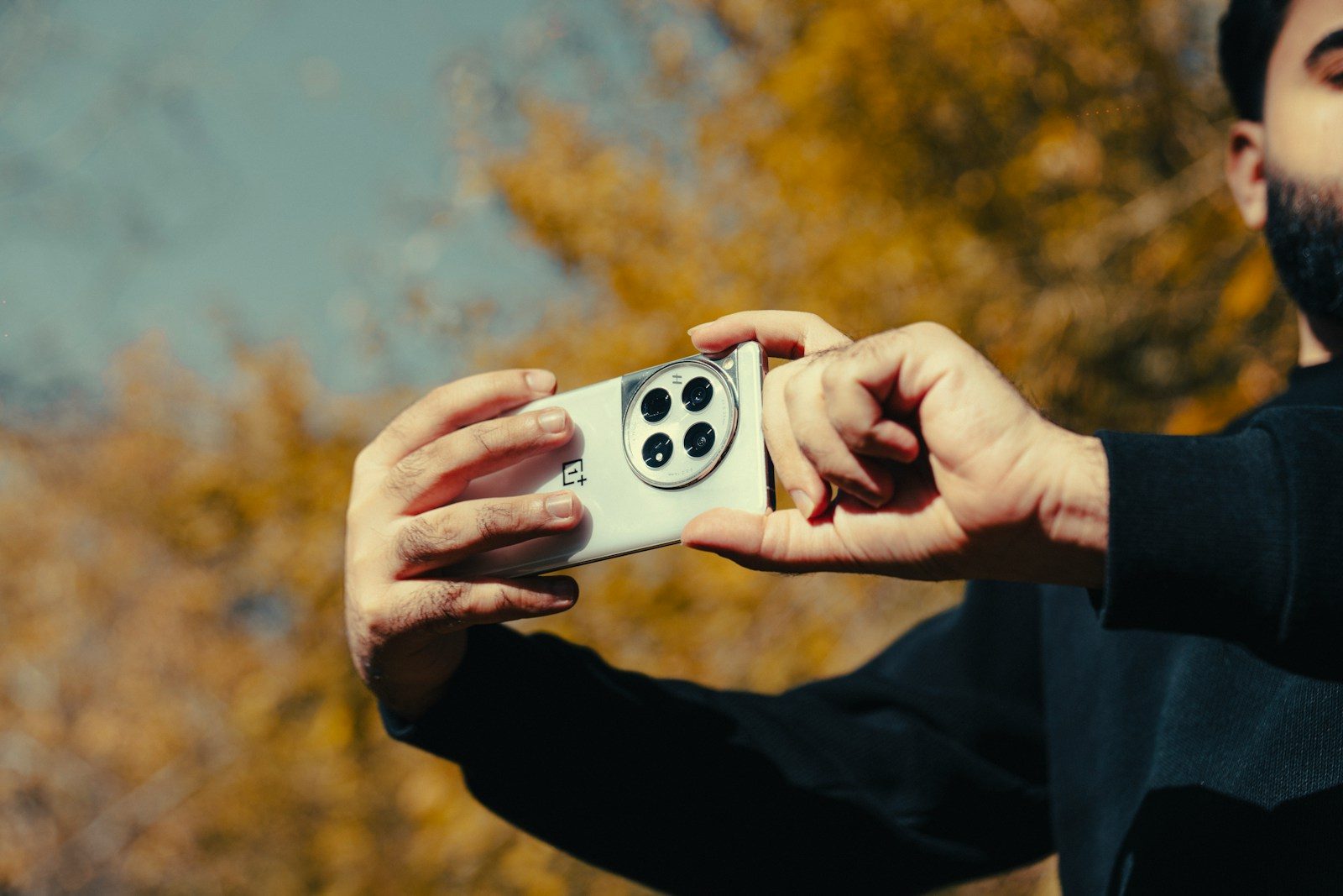 Man taking a selfie with a modern smartphone outdoors
